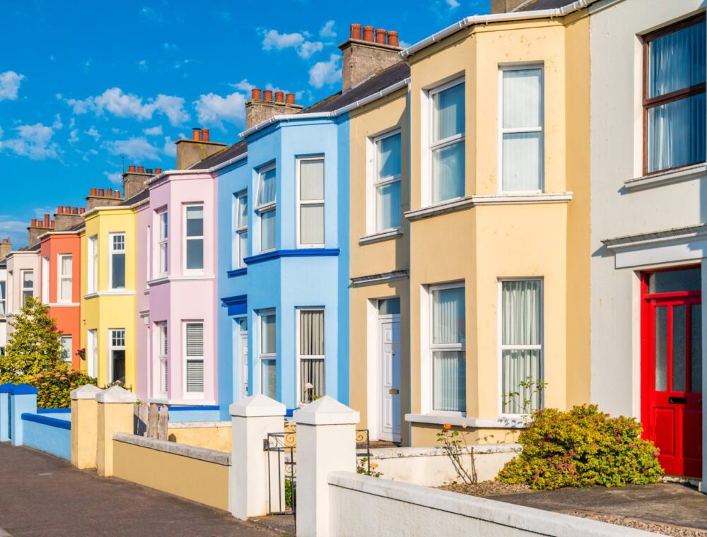 Colourful houses along a street on a sunny day.