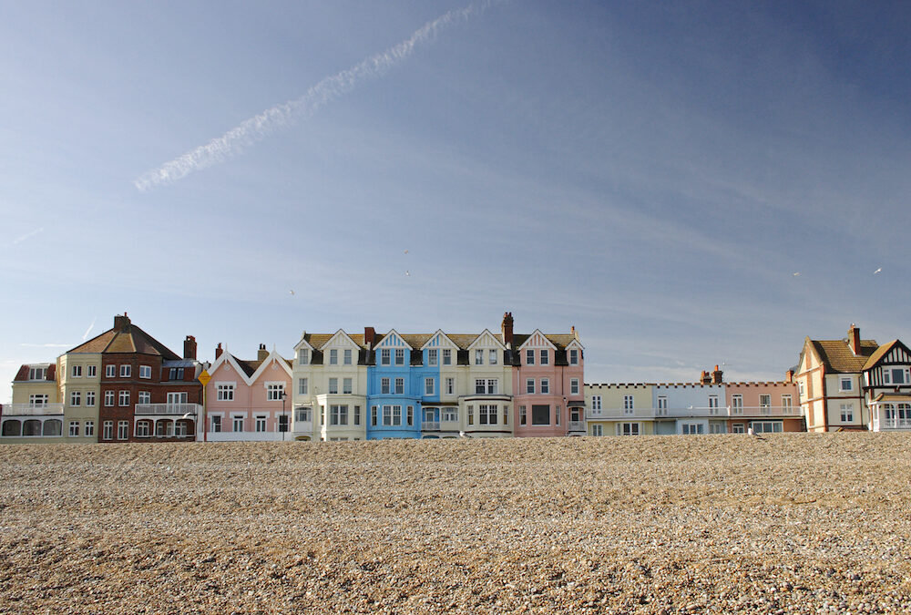 A colourful row of seafront houses in the popular coastal town of Aldeburgh, Suffolk, UK on a sunny spring day.